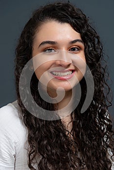 Close-up vertical portrait of young beautiful woman looking at camera