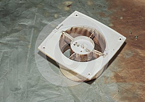 Close-up of a very dirty kitchen exhaust fan. Fan before preventive cleaning and washing. Dirty details