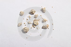 Flat lay or top view very small kidney stones at white background