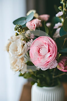 Close-up a vibrant bouquet of flowers, arranged in a white vase