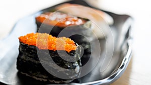 Close up Vibrant Tobiko Gunkan Sushi Focus on a Ceramic Plate