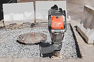 Close-up of a vibrating rammer on the road