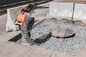 Close-up of a vibrating rammer on the road