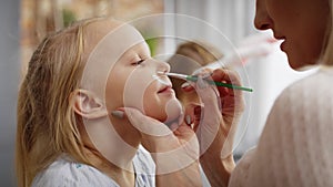 Close up video of face painting for little Easter bunny.