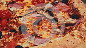 Close-up video of pizza capriciosa in a pizzeria