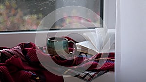 Close up video. Steaming coffee cup on a rainy day window background. cozy atmosphere, in cold weather. Rainy Day Mood.