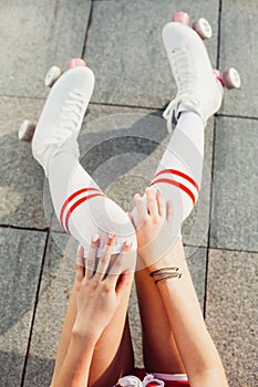 Close up view from above of woman`s legs in a vintage roller skates, golfs. photo