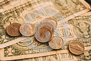 Close up view of American dollar bills and coins as background. Heap of American dollars for design.