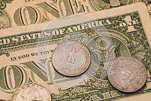 Close up view of American dollar bills and coins as background. Heap of American dollars for design.