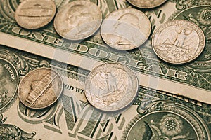 Close up view of American dollar bills and coins as background. Heap of American dollars for design.