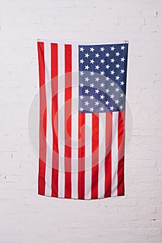 close up view of american flag hanging on white