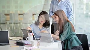 Close up view of application developer team brainstorming on their project in co working space