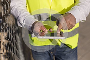 Close up view of an Architect or Engineer hands using tablet on