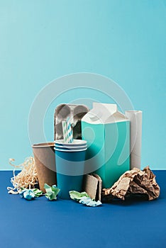 close up view of arranged cardboard and paper disposable garbage on blue background