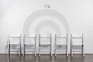 close up view of arranged empty chairs in hall for visitors of job interview