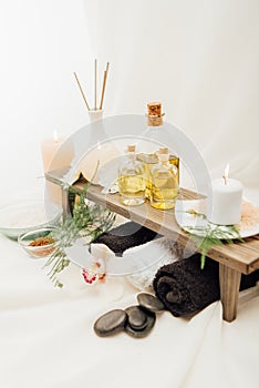 close up view of arrangement of spa treatment accessories with essential oil, salt and candle