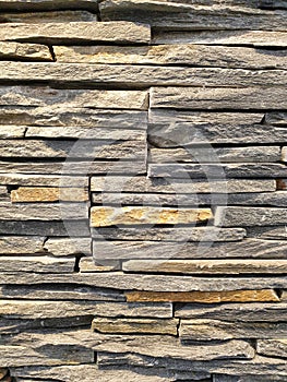 Close-up view of an artificial wall made of stone slabs.