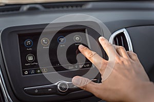 Close-up view Asian male hand touching LCD screen in modern car