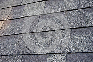 Close up view on asphalt roofing shingles background.