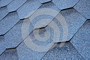 Close up view on asphalt roofing shingles background.