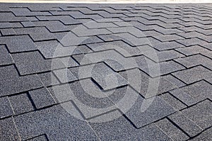 Close up view on Asphalt Roofing Shingles Background. Roof Shingles - Roofing.