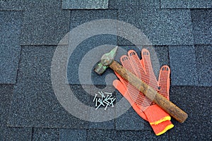 Close up view on Asphalt Roofing Shingles Background. Roof Shingles - Roofing. Asphalt Roofing Shingles Hammer, Gloves and Nails