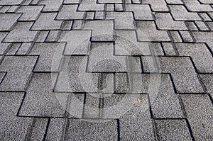 Close up view on Asphalt Roofing Shingles Background. Roof Shingles - Roofing. Roof shingles covered with frost