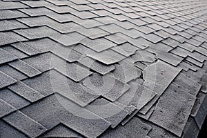 Close up view on Asphalt Roofing Shingles Background. Roof Shingles - Roofing. Shingles roof damage covered with frost.