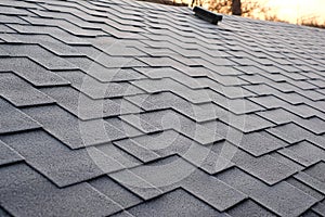 Close up view on Asphalt Roofing Shingles Background. Roof Shingles - Roofing. Shingles roof damage covered with frost.
