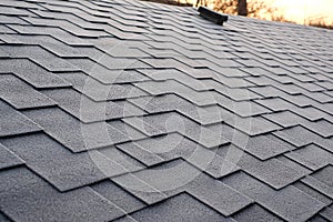 Close up view on Asphalt Roofing Shingles Background. Roof Shingles - Roofing. Shingles roof damage covered with frost. photo