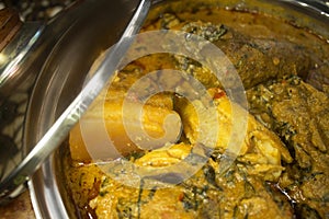 A close up view of assorted meat in a pot of Nigerian soup