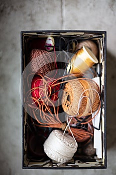 Assorted twines and string in an open container
