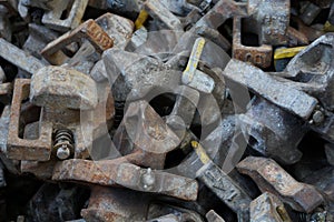 Close up view on automatic twist Locks piled in lashing bin situated on the container vessel.