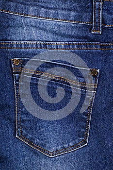 Close-up. The view of the back pocket of denim trousers
