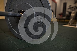 Close up view of barbell on floor in gym