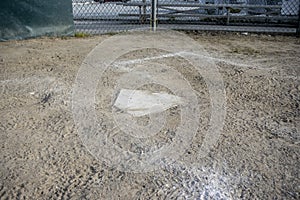 Close up view of a base on a clean baseball field on a bright, sunny day