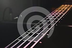 Close-up view on bass guitar strings and frets photo