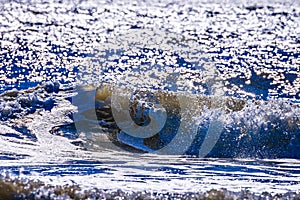 Close up view of beautiful blue ocean wave with white foam