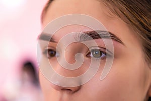 Close up view of beautiful brown female eye. Perfect trendy eyebrow. Good vision, contact lenses, brow bar or fashion eyebrow