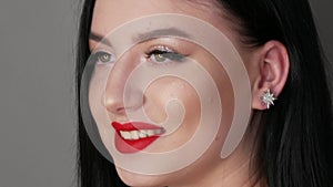 Close up view of beautiful girl model with big lips painted with red lipstick. Young woman posing with bright evening