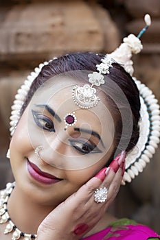 Close up View of Beautiful indian odissi Dancer in traditional clothing with make-up and jewelry.