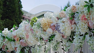 Close up view of beautiful place made with wooden square and floral decorations for outside wedding ceremony in wood in