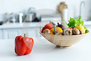 close-up view of bell pepper and bowl with fresh vegetables
