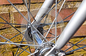 Close up view at a bicycle wheel with metal spokes