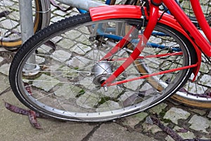 Close up view at a bicycle wheel with metal spokes