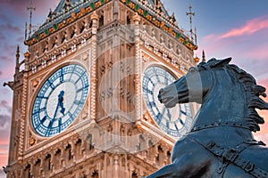 Close up view of the Big Ben clock tower and horse statue monument in the foreground.