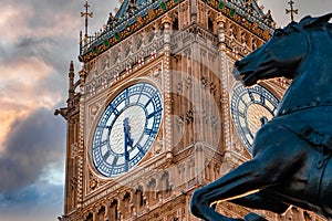 Close up view of the Big Ben clock tower and horse statue monument in the foreground.