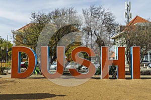 Close up view of big orange letters of word DUSHI. Willemstad. Curacao. photo