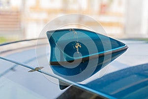 Close-up view of the bird poop dropping on the blue car antenna