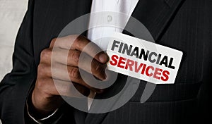 Close up view of a black man holding a business card. A young African businessman takes out a business card from the pocket of his